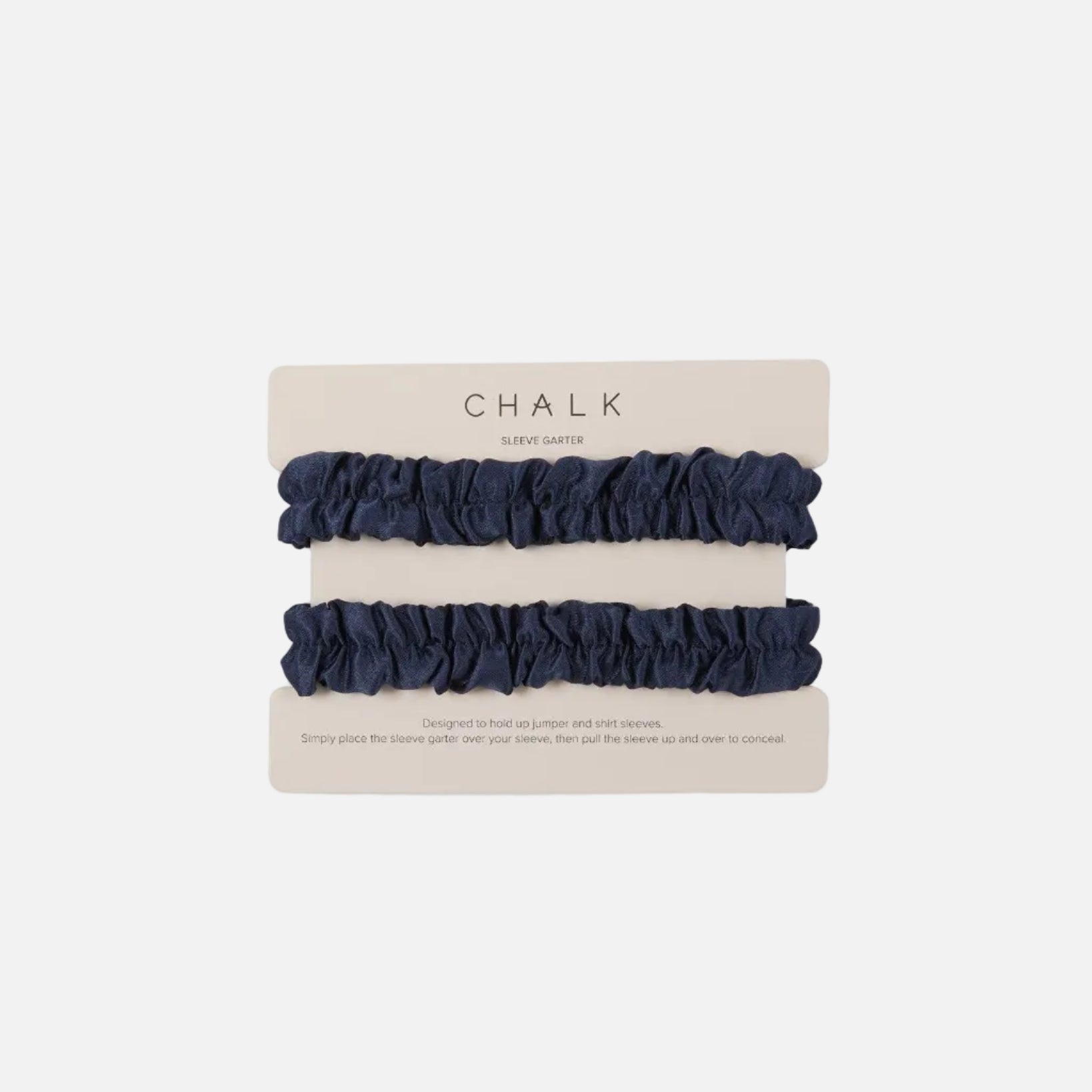 Two navy blue ruffled scrunchie sleeve garters on a beige cardboard display card labeled CHALK, photographed on a clean white background.