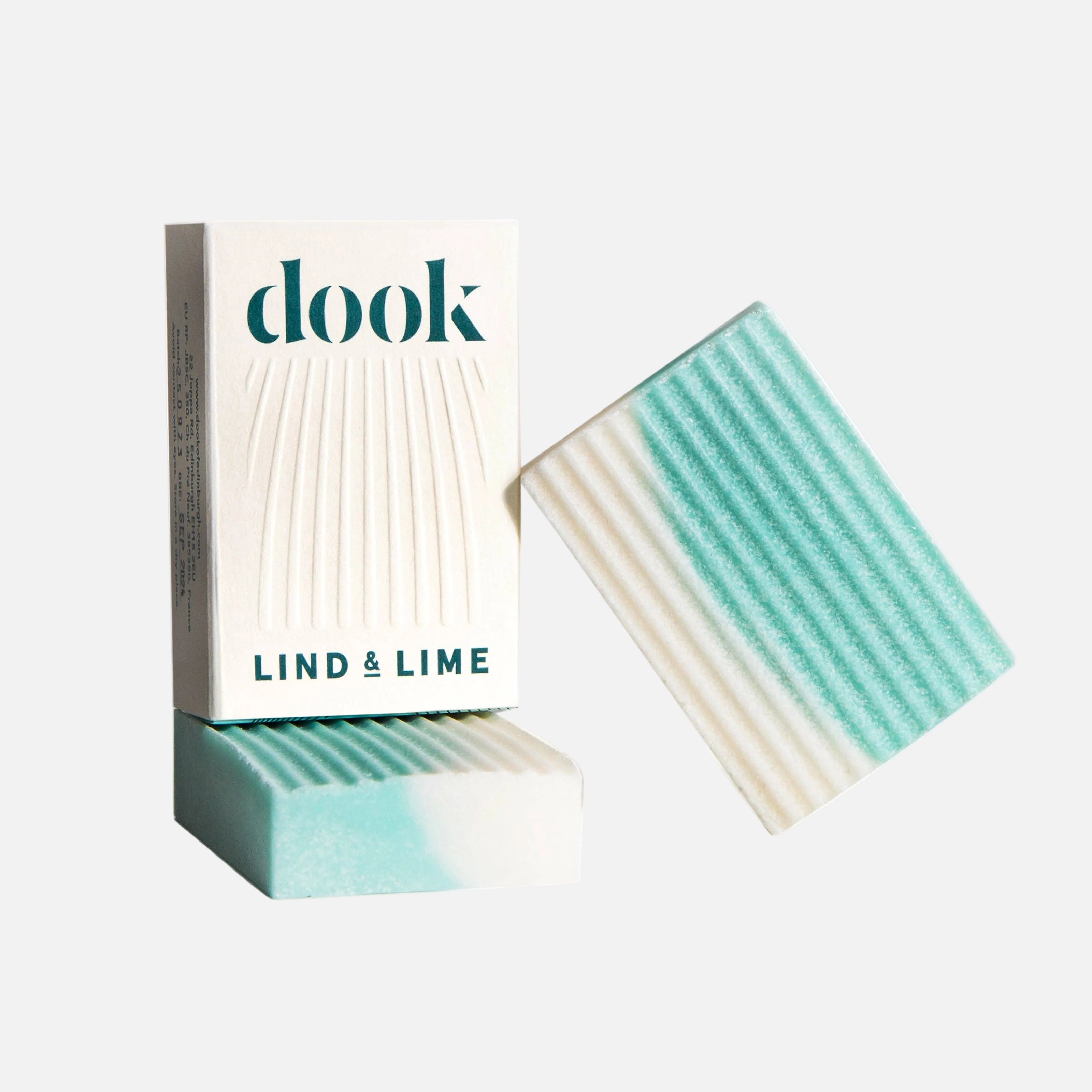 Bar of soap with striped design and packaging labeled 'dook' on a white background