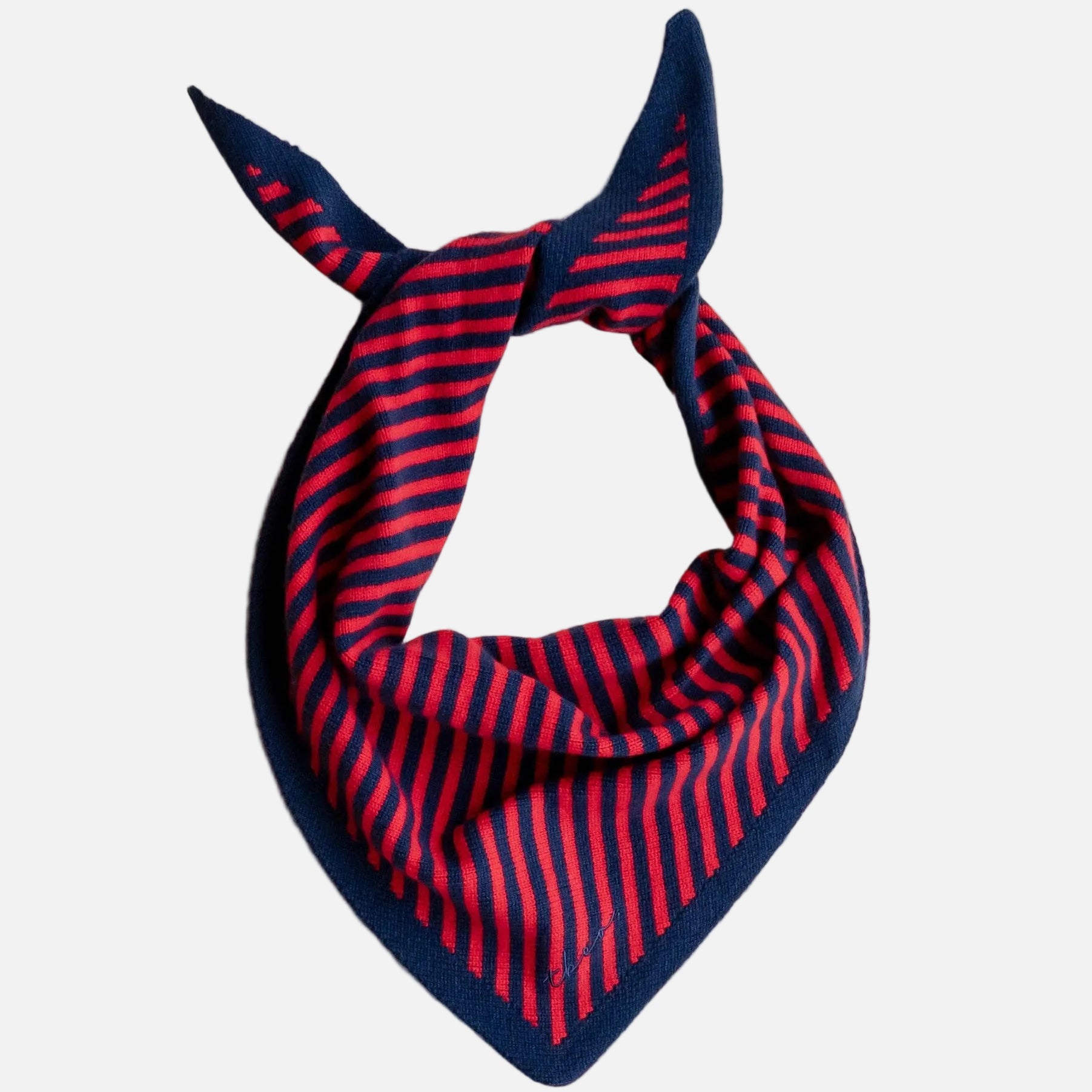 Navy and red scarf bandana on a beige surface