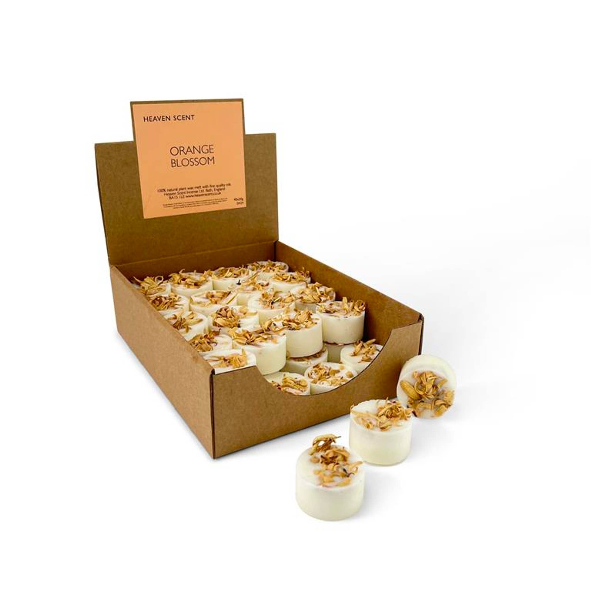 Box of 'Orange Blossom' candles with three candles displayed in front on a white background