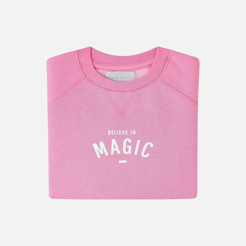 Pink sweatshirt with 'BELIEVE IN MAGIC' text on a white background