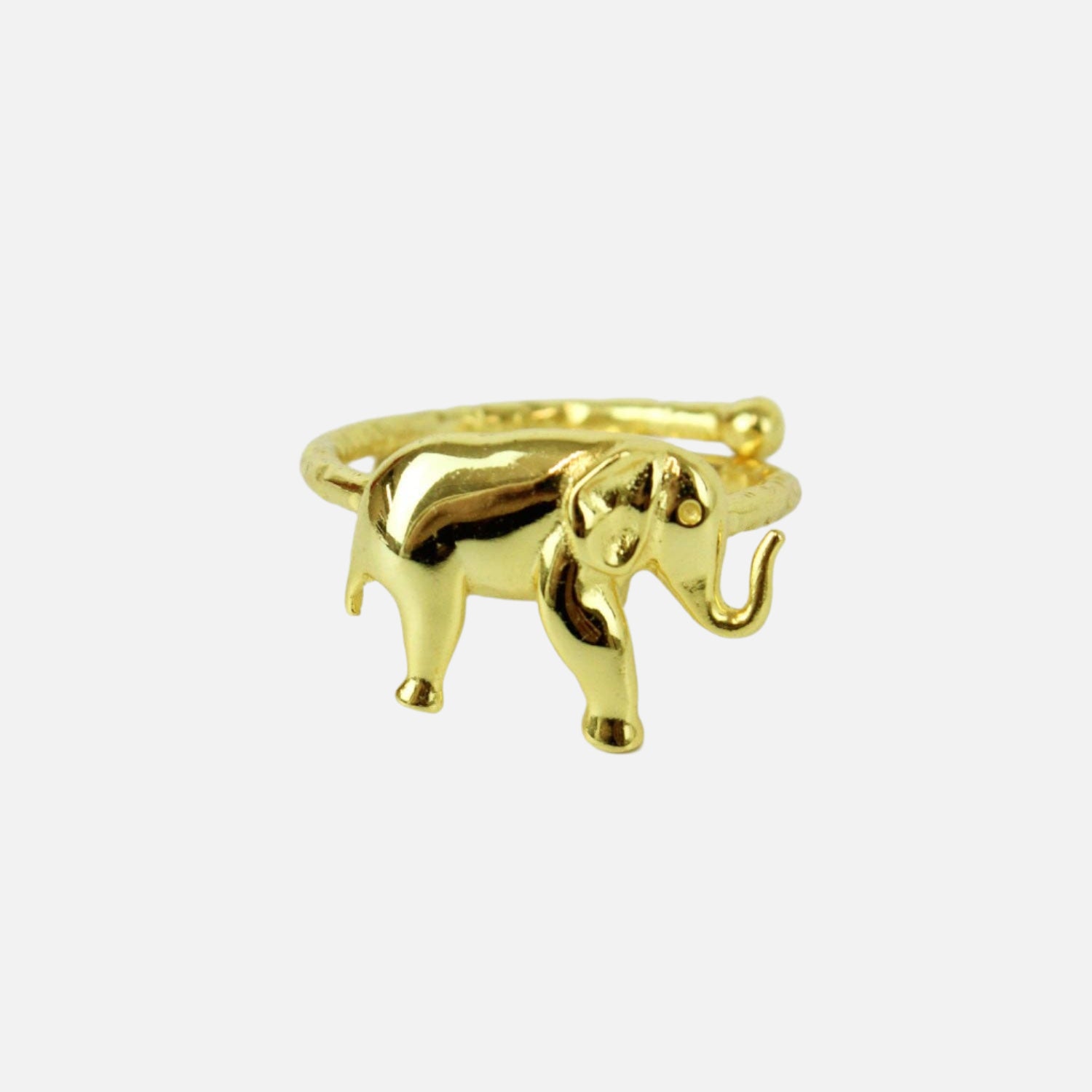 Gold elephant-shaped ring on a white background
