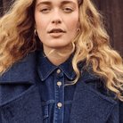 Woman wearing a blue denim shirt and navy wool jacket