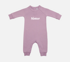 Purple baby onesie with 'Sister' text on a white background