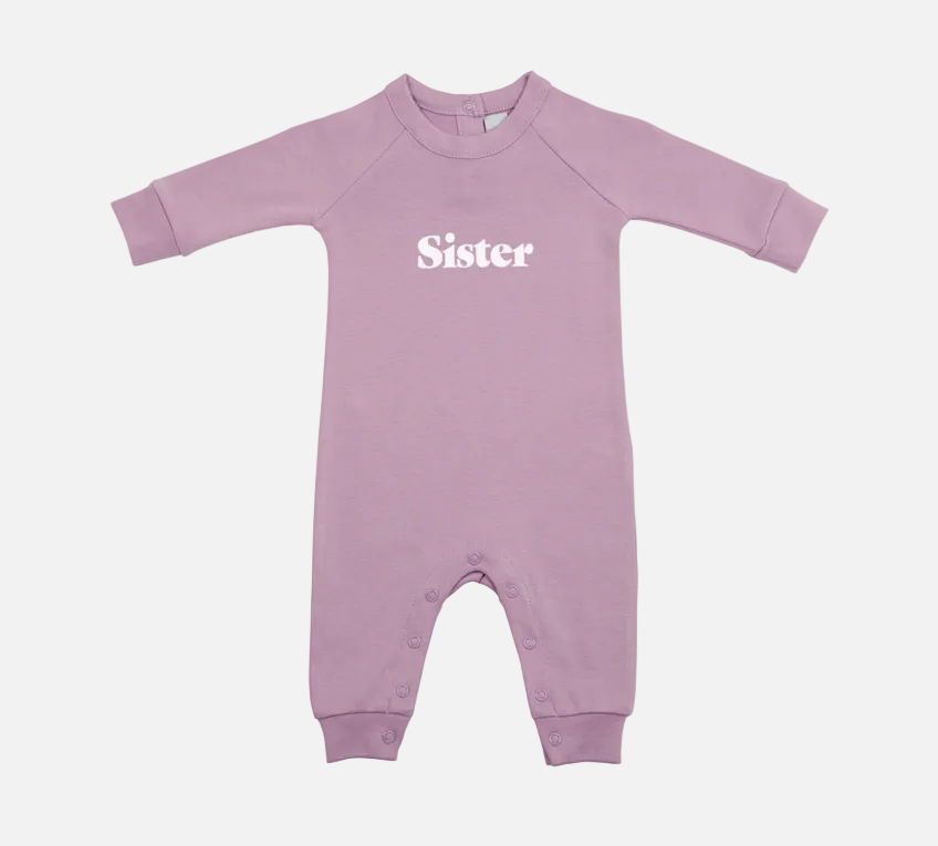 Purple baby onesie with 'Sister' text on a white background