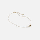 Gold necklace with pearls on a white background