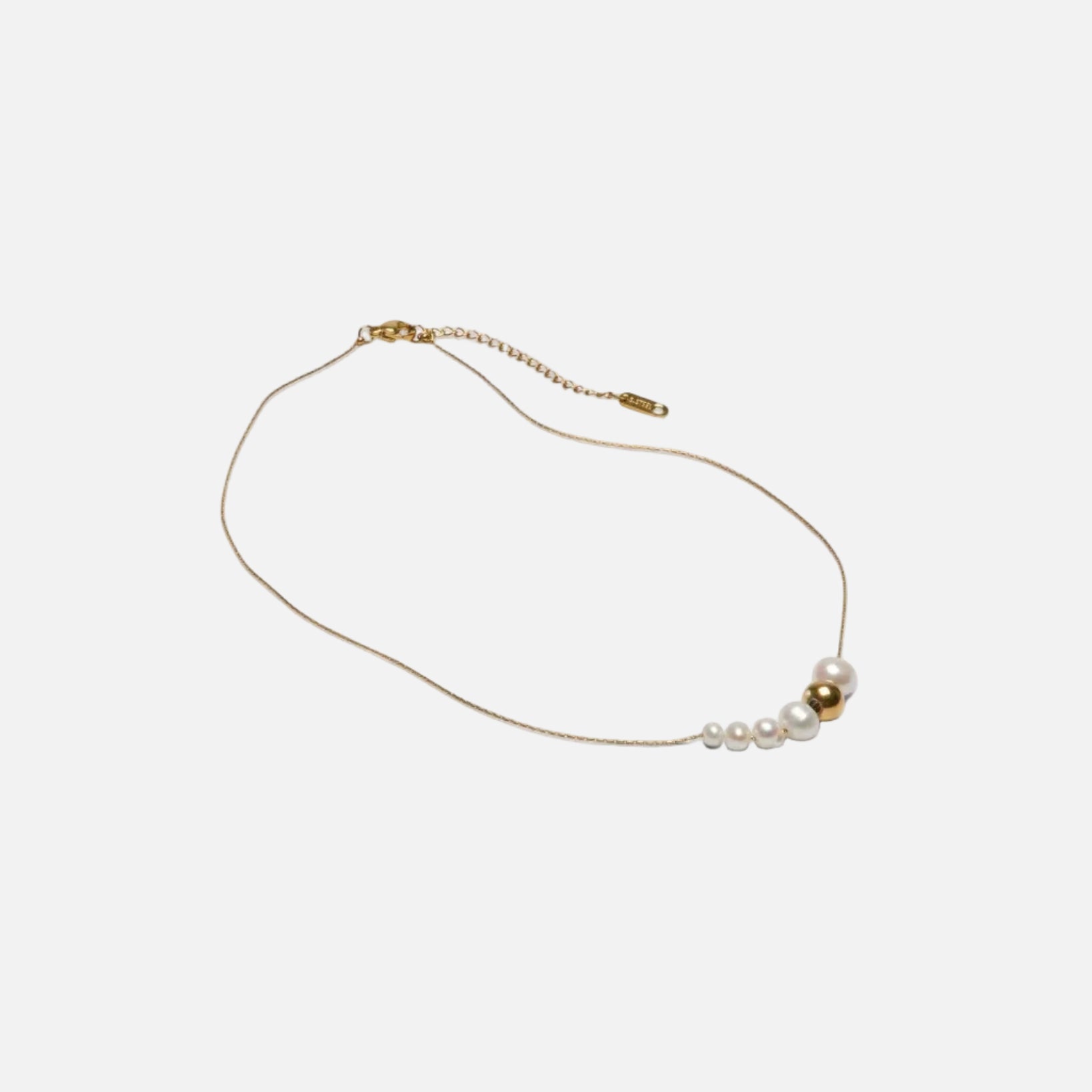 Gold necklace with pearls on a white background