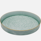 Pale blue ceramic tray with decorative pattern on a white background