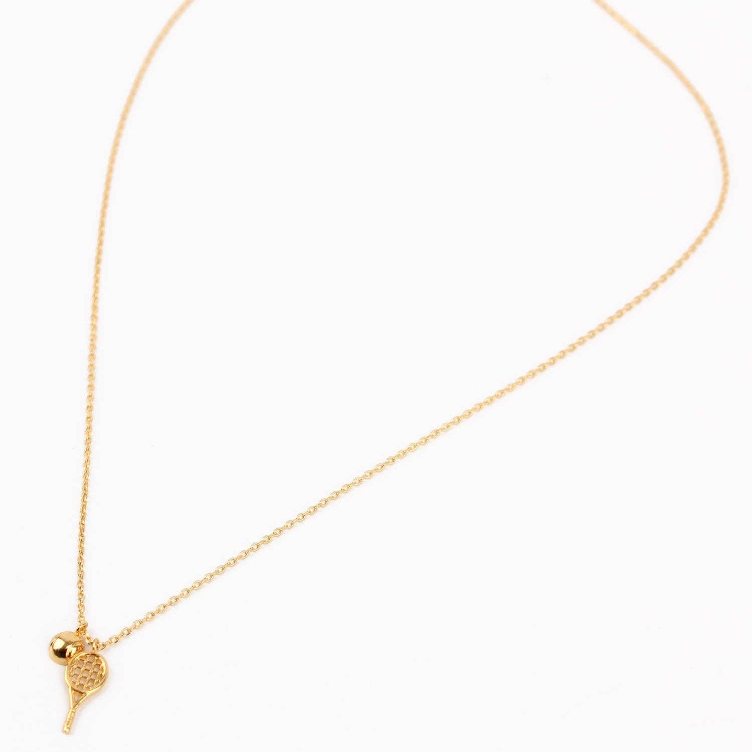 Gold necklace with a heart-shaped pendant on a white background