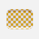 Checkered tray with yellow and white squares on a white background