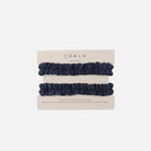 Two navy blue ruffled scrunchie sleeve garters on a beige cardboard display card labeled CHALK, photographed on a clean white background.