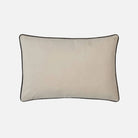 Beige pillow with a black border on a white background