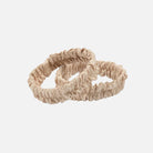 Two beige sleeve garters on a white background