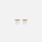 Pair of gold earrings with spherical pearls on a white background