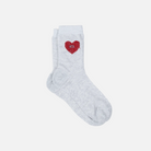 Gray sock with a red heart design on a light gray background