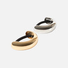 Two hair ties, one gold and one silver, on a white background