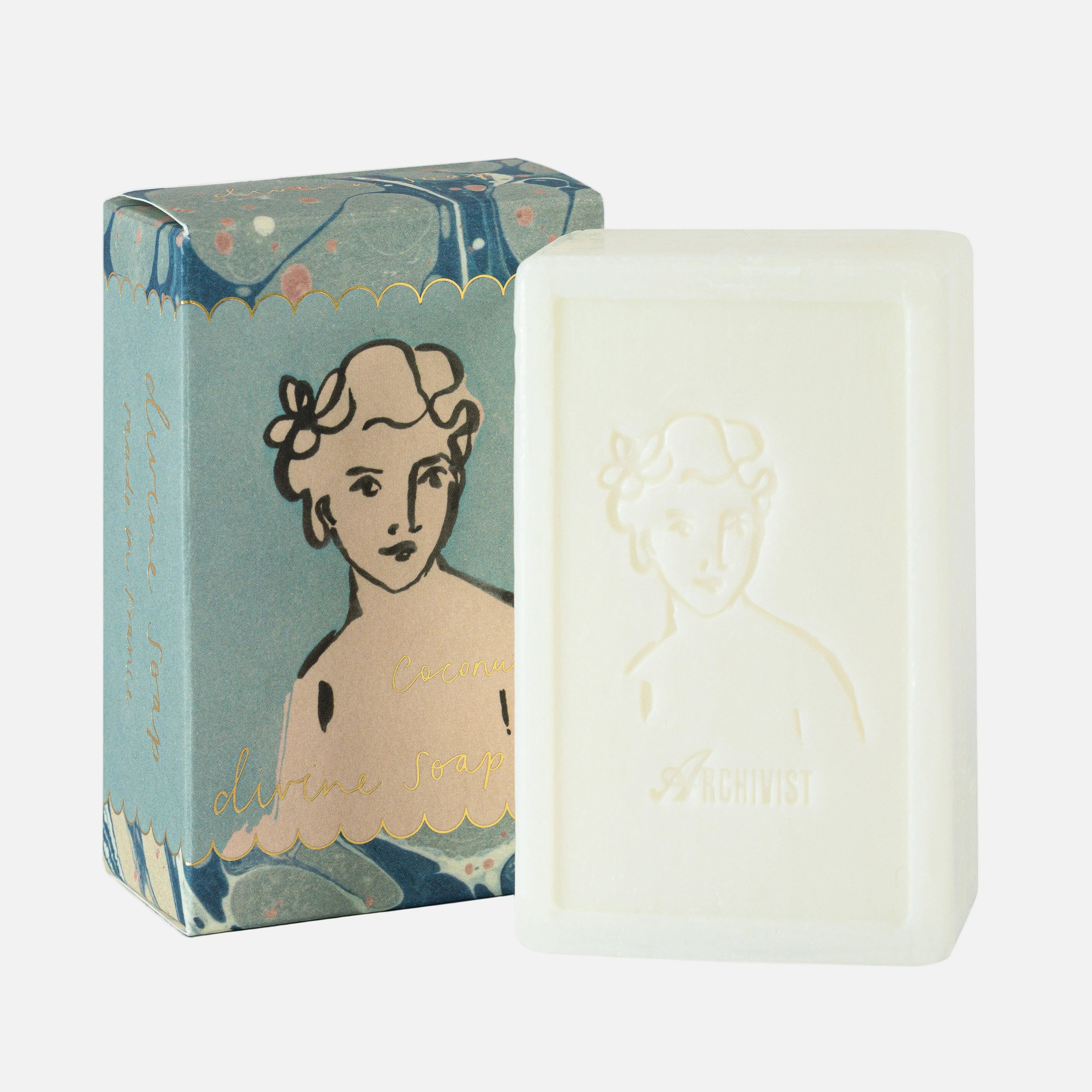 Bar of soap with decorative packaging featuring a woman's face on a white background