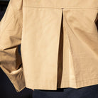 Close-up of a beige jacket with a dark background