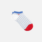 White ankle sock with blue stripes and red toes on a light gray background