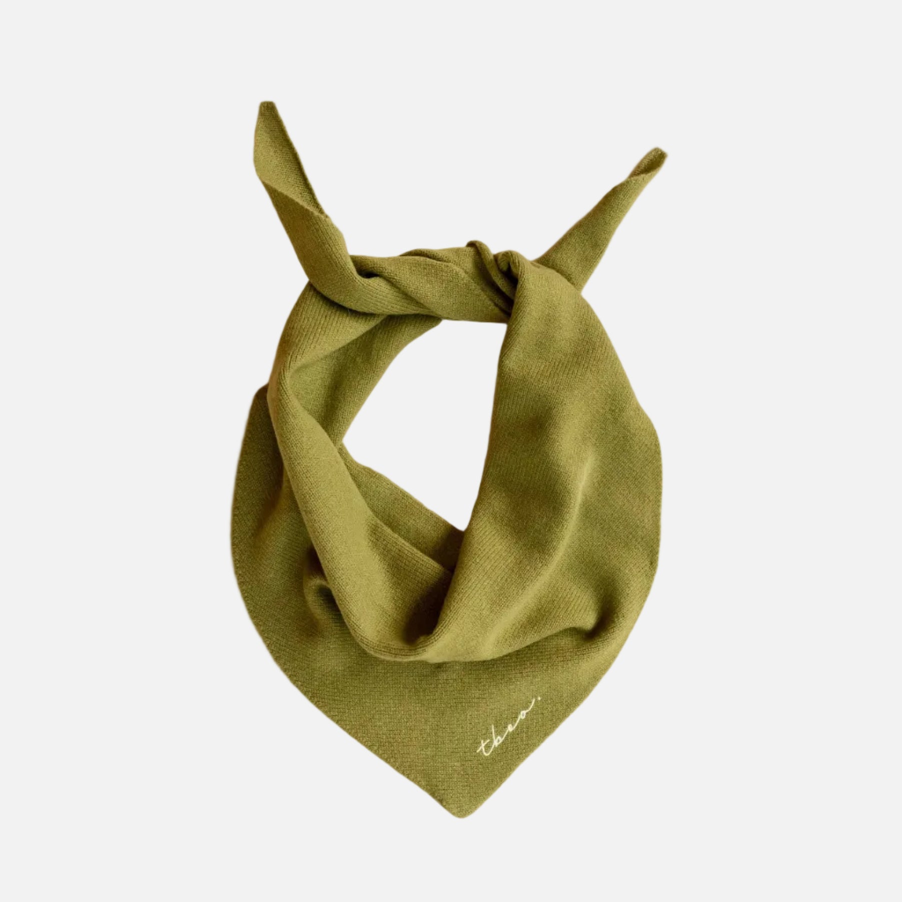 Olive green triangle scarf on a light wooden surface