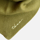 Olive green triangle scarf - close up showing TBCo logo