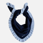 Navy blue triangle scarf with light blue ruffles on a beige background