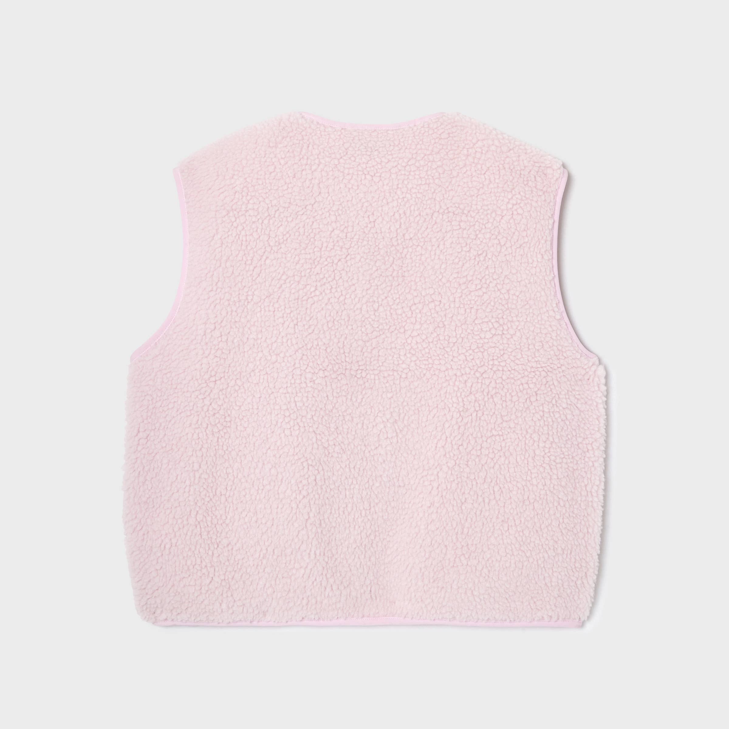 Pink fleece vest on a light gray background