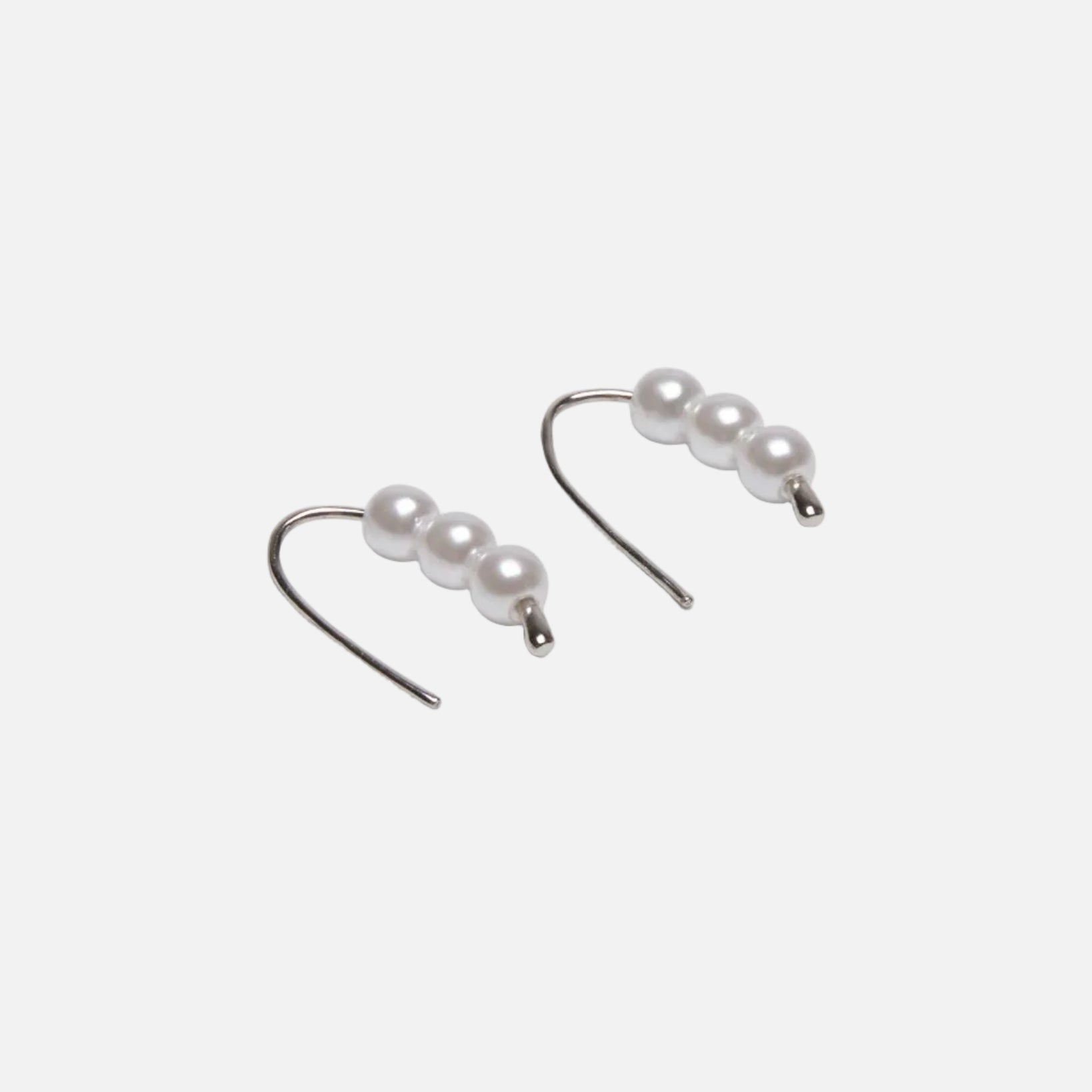 Three pearls on a drop earring silver on a white background