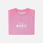 Pink sweatshirt with 'BELIEVE IN MAGIC' text on a white background